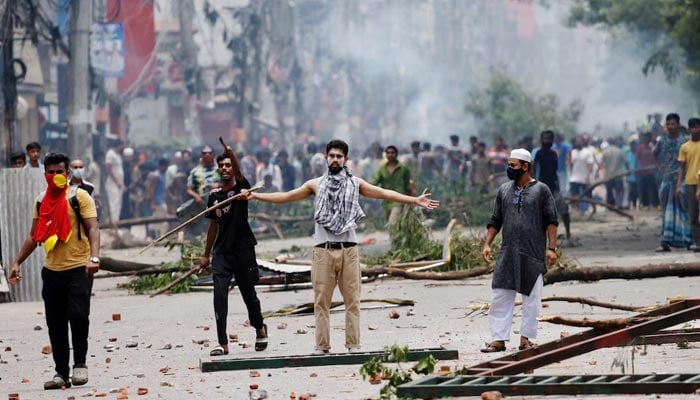 A demonstrator gestures as protesters clash with Border Guard Bangladesh (BGB) and the police outside the state-owned Bangladesh Television as violence erupts across the country after anti-quota protests by students, in Dhaka, Bangladesh, July 19, 2024. — Reuters