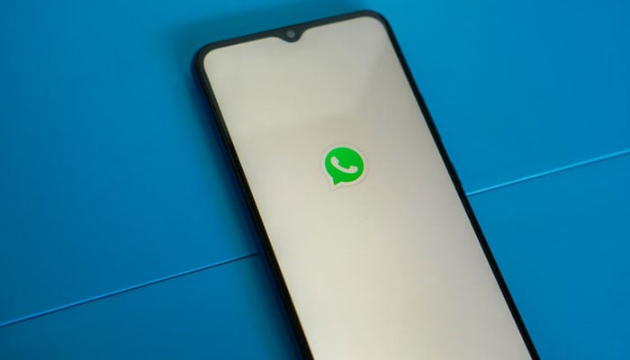 The WhatsApp logo displayed on a phone screen. — Unsplash