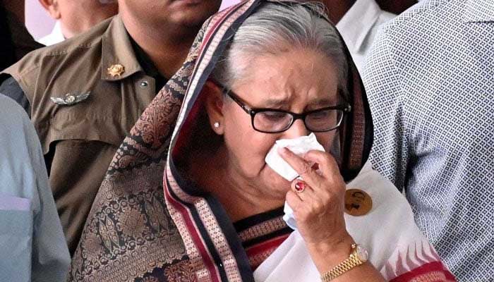 In this handout photograph taken and released on July 25, 2024 by Bangladesh Prime Minister´s Office, then prime minister Sheikh Hasina (C) weeps while she visits a metro station in Mirpur vandalised by students during the anti-quota protests. — AFP