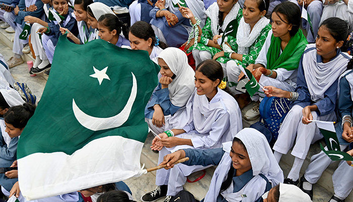 Students wave Pakistans national flag during Independence Day celebrations at the mausoleum of founding father Quaid-e-Azam Mohammad Ali Jinnah in Karachi on August 14, 2024. — AFP