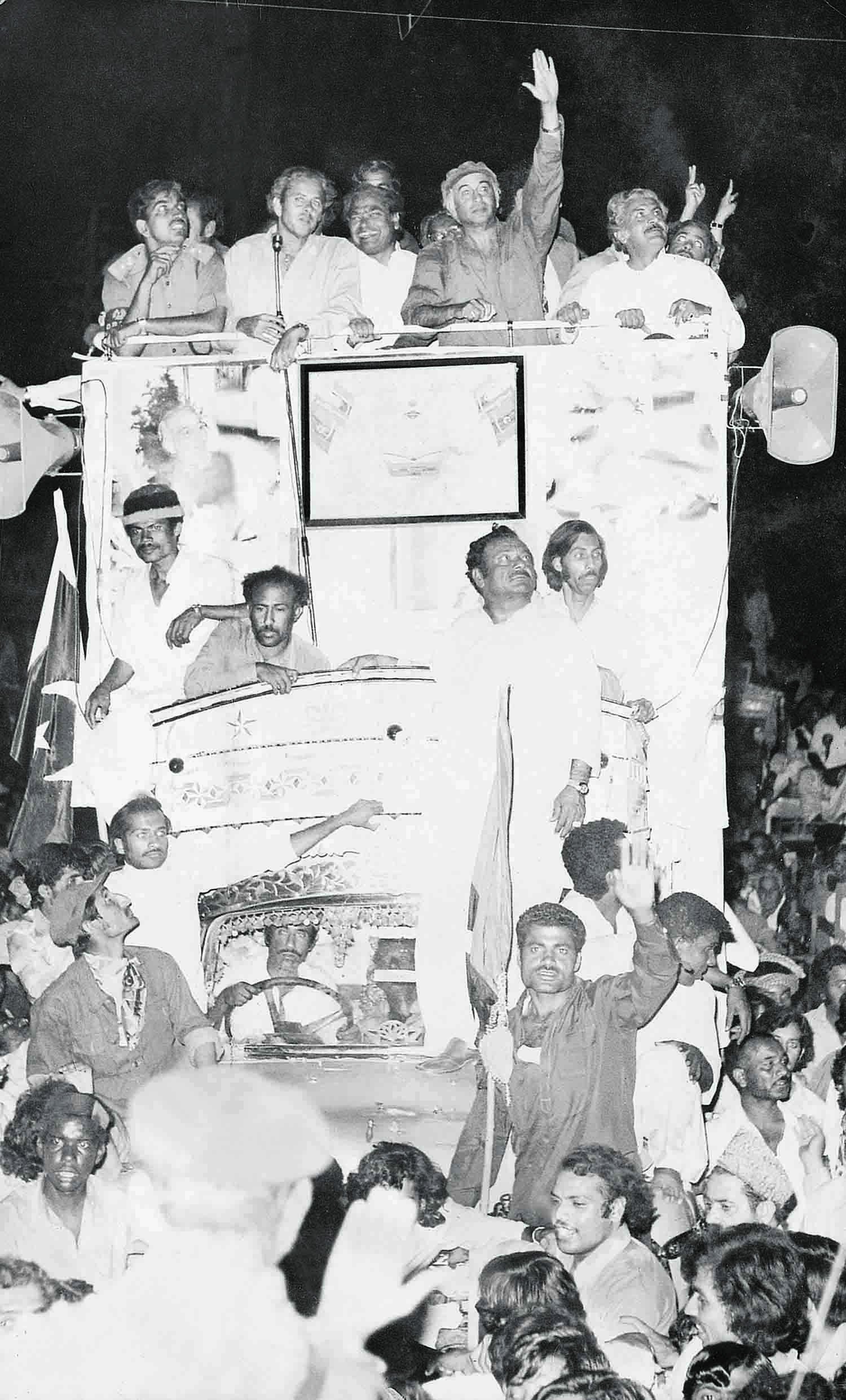 Former Prime Minister Zulfikar Ali Bhutto is seen with party members in a PPP rally. — Press Information Department/File