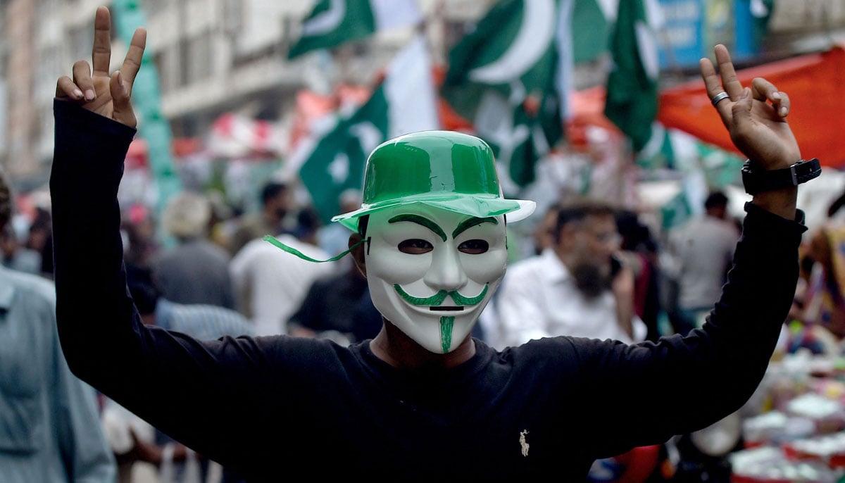 A man wearing a mask with colours of Pakistan´s national flag, poses at a market in Karachi on August 12, 2024, ahead of the country´s Independence Day. — Reuters