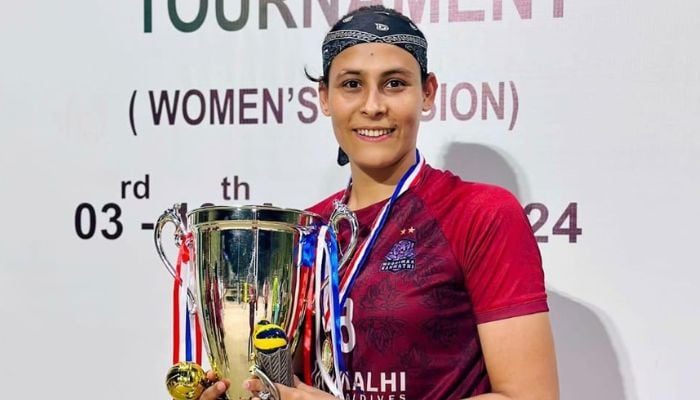 Azra Farooq posing with the winners trophy at the Kings Cup Volleyball tournament in Maldives. — Reporter