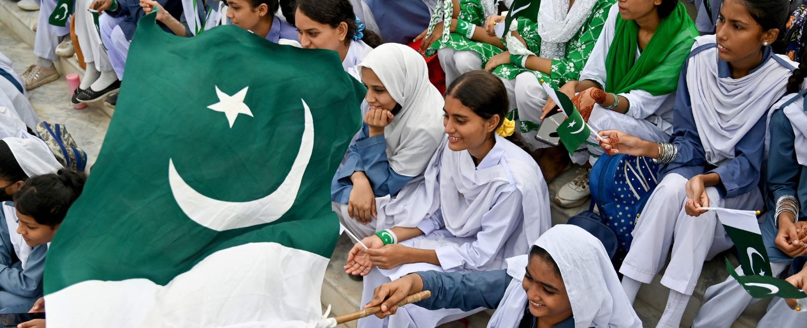 Students wave Pakistans national flag during Independence Day celebrations at the mausoleum of founding father Quaid-e-Azam Mohammad Ali Jinnah on August 14, 2024 in Karachi, Sindh, Pakistan. — AFP