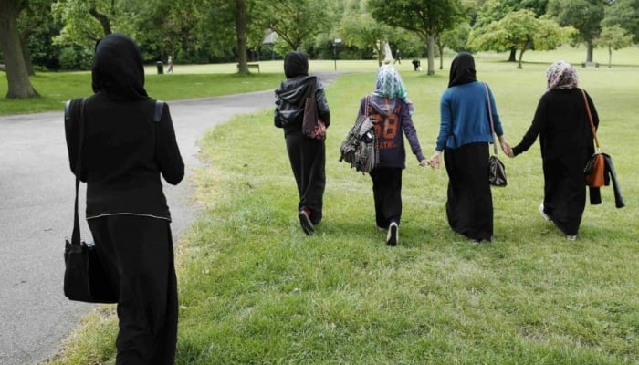 Muslim women walk in the park after finishing a GCSE exam near their school in Hackney, London. —Reuters/File