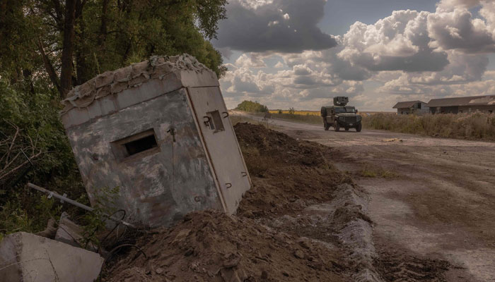 Ukrainian servicemen drive an armoured military vehicle past a destroyed border crossing point with Russia, in the Sumy region, on August 14, 2024, amid the Russian invasion of Ukraine. — AFP