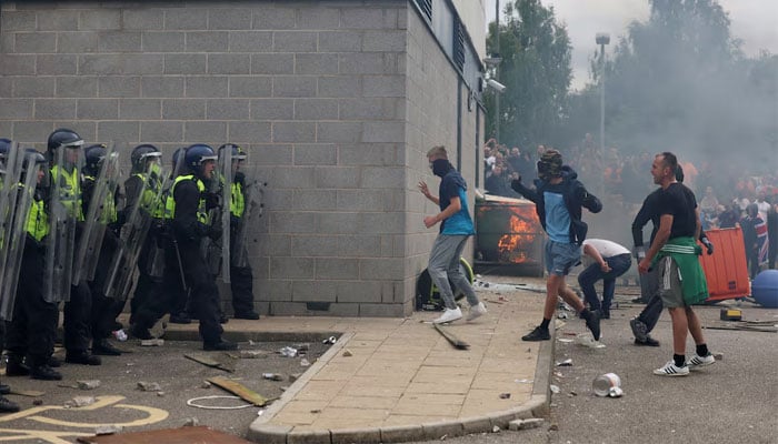 Demonstrators clash with police officers during an anti-immigration protest, in Rotherham, Britain, August 4, 2024. — Reuters