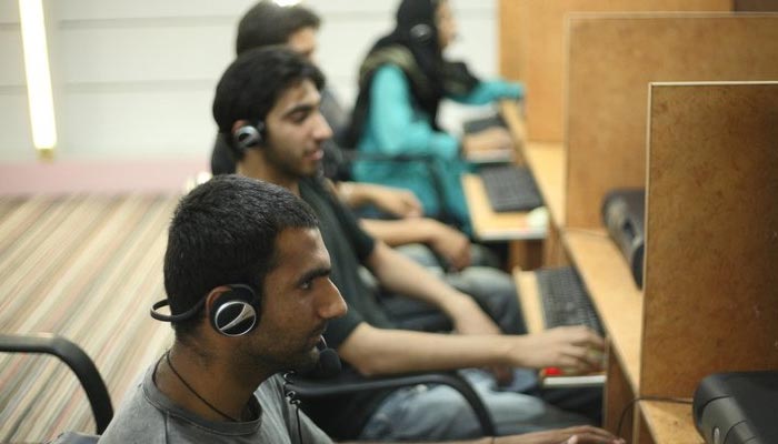 The picture shows people working at a call centre. — Facebook/@One Call Bpo