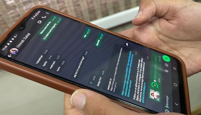 The picture shows a person using WhatsApp. — Geo.tv
