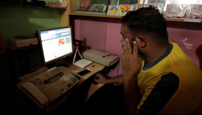 A man explores social media on a computer at an internet club in Islamabad. — Reuters/File