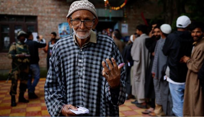 A man shows his ink-stained finger after voting at a polling station, during the fourth general election phase, in IIOJKs Pulwama district on May 13, 2024. — Reuters