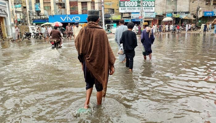 Commuters are facing difficulties in transportation due to stagnant rainwater causing of poor sewerage system after heavy downpours of monsoon season, at Ghanta Ghar Chowk in Sukkur on Sunday, August 18, 2024. — PPI