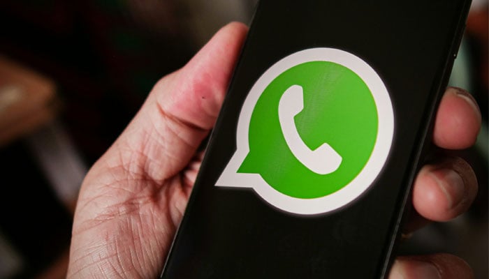 A representational image showing the WhatsApp logo on a phone screen. — Unsplash