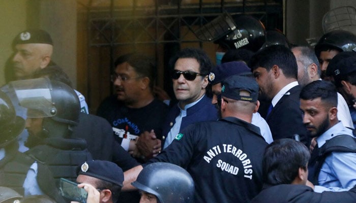 Security officers escort Pakistans former Prime Minister Imran Khan, as he appeared in Islamabad High Court, Islamabad, Pakistan May 12, 2023. — Reuters