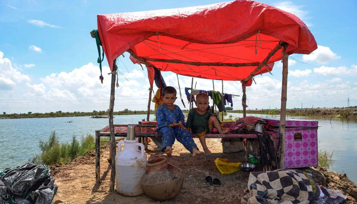 Children displaced by flood, sit in a make-shift tent after heavy monsoon rains at Sohbatpur in Jaffarabad district, Balochistan province on August 19, 2024. — AFP