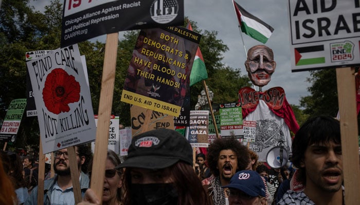 Protestors shout pro-Palestinian slogans while marching on the sidelines of the Democratic National Convention (DNC), in Chicago, Illinois, US, August 19, 2024.