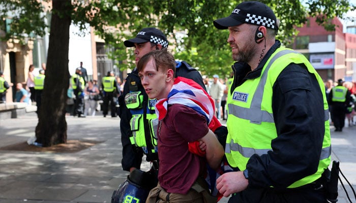 An anti-immigration protester is detained by police officers, in Newcastle, Britain August 10, 2024. —Reuters