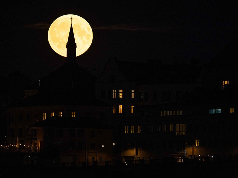 This photograph shows a Super Blue Moon rising behind Sodermalm, in Stockholm, on August 19, 2024. — AFP