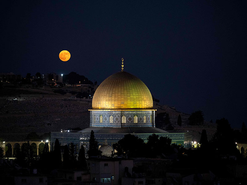 A super blue moon rises behind the Dome of the Rock at the Al-Aqsa Mosque compound in Jerusalem on August 19, 2024. — AFP