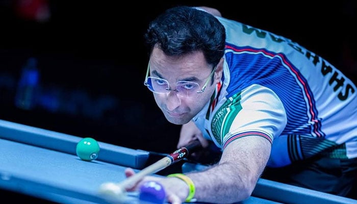 In this undated photo, Pakistans star snooker player Shahram Changezi aims a ball during a snooker match. — Geo News/reporter