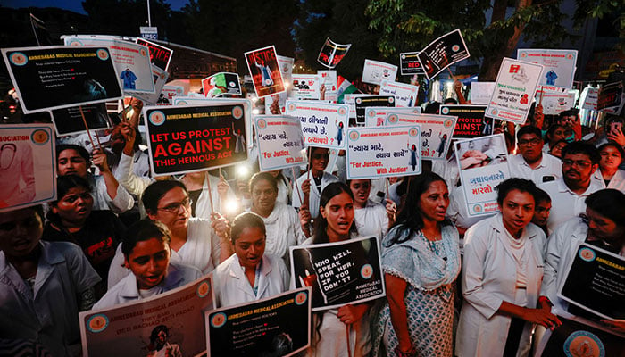 Female doctors hold posters and shout slogans during a protest march demanding justice following the rape and murder of a female trainee medic at a hospital in Kolkata, in Ahmedabad, India, August 17, 2024. — Reuters