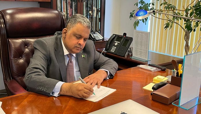 Pakistans newly-appointed Ambassador to the US Rizwan Saeed Sheikh signs a document in this image released on August 22, 2024. — Facebook/Pakistan Embassy US