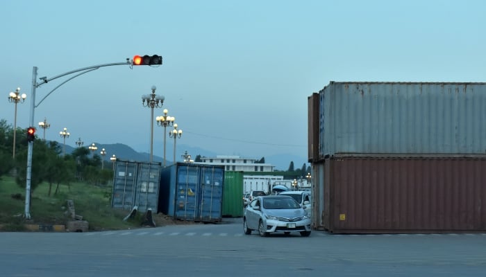 A view of heavy shipping containers placed at D-chowk for road block in Islamabad on August 21, 2024. —Online