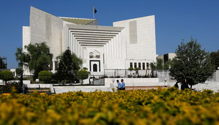 Police officers walk past the Supreme Court of Pakistan building, in Islamabad on April 6, 2022. — Reuters