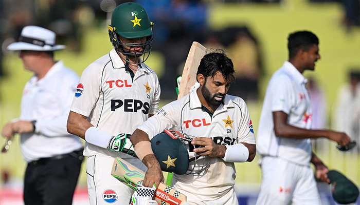 Pakistans Shaheen Shah Afridi (2L) and Mohammad Rizwan (2R) walk back to the pavilion at the end of first innings on the second day of first Test cricket match, Pakistan vs Bangladesh, Rawalpindi Cricket Stadium, August 22, 2024. — AFP