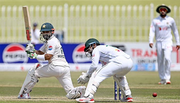 Pakistans Mohammad Rizwan (L) plays a shot as Bangladeshs wicketkeeper Litton Das fields the ball during the second day of the first Test cricket match between Pakistan and Bangladesh, Rawalpindi Cricket Stadium, August 22, 2024. — AFP