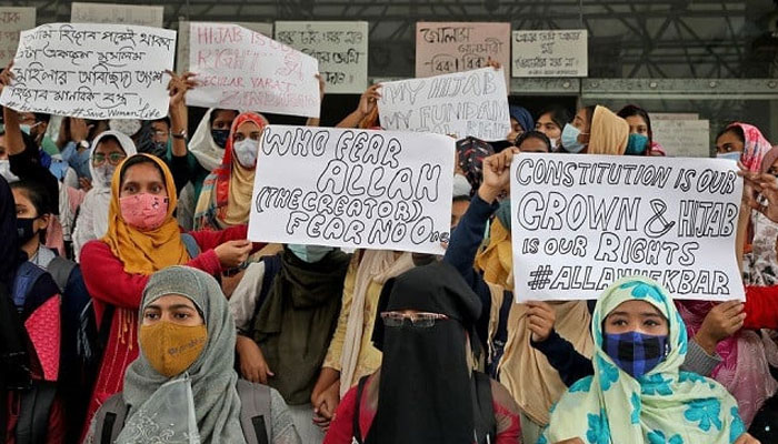 Muslim students display placards during a protest against the recent hijab ban in few colleges of Karnataka state, at Aliah University in Kolkata, India, February 9, 2022. — Reuters