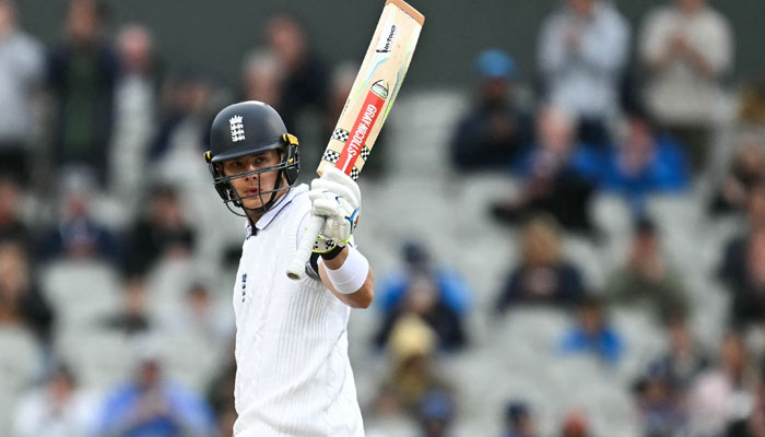 England’s Jamie Smith celebrates his half-century on day two of the first Test match between England and Sri Lanka at Old Trafford cricket ground in Manchester, north-west England on August 22, 2024. — AFP