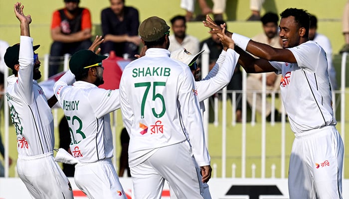 Bangladeshs Shoriful Islam (R) celebrates with teammates after taking the wicket of Pakistans Saim Ayub (not pictured) during the fourth day of the first Test cricket match, Pakistan vs Bangladesh, Rawalpindi Cricket Stadium, August 24, 2024. — AFP