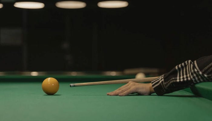 A representational image showing a snooker player taking a shot. — Pexels/File