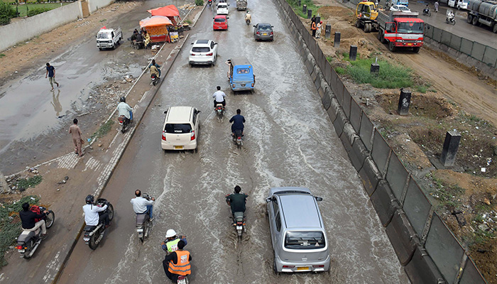 Commuters are facing difficulties due to accumulated rainwater at University Road, Karachi. — Online