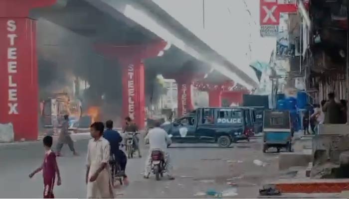 A still taken from a video shows a police van after armed clash between two groups in Golimar, Karachi on August 25, 2024. — Geo News