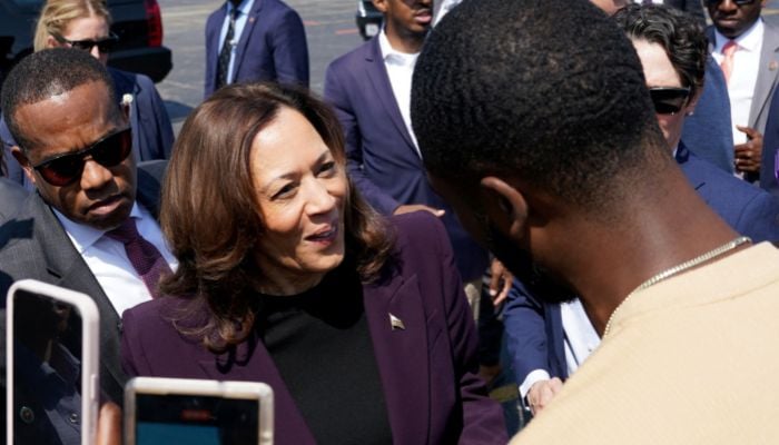 Democratic presidential nominee and US Vice President Kamala Harris speaks with supporters as she walks to board Marine Two to depart from the Soldier Field landing zone in Chicago, Illinois, US on August 23, 2024. — Reuters