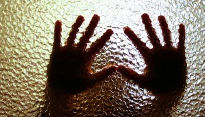 A representational image of a persons hands against a frosted glass wall. — AFP/File