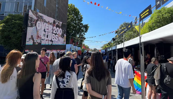 Students walk past stalls during the orientation week at The University of Sydney, in Camperdown, Australia February 15, 2023. — Reuters