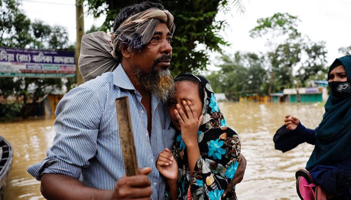 A man cries after meeting his daughter after four days as severe floods hit the Lalpol area in Feni, Bangladesh, August 25, 2024. — Reuters