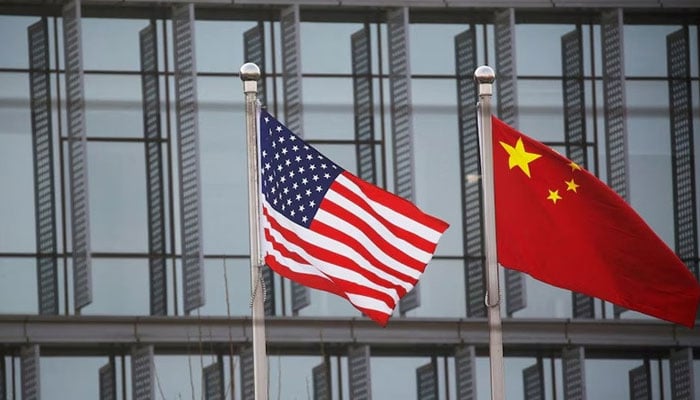 Chinese and US flags flutter outside a building in Beijing, China. — Reuters/File