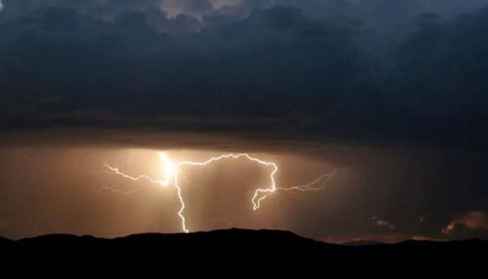 Lightning strikes during monsoon storms in the desert area of Baker, California, July 19, 2006. — Reuters