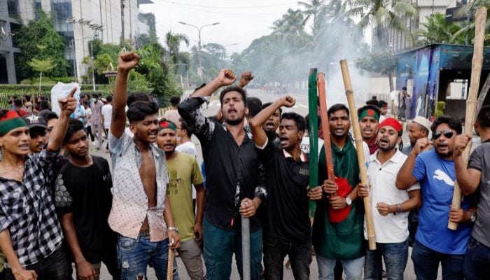 Demonstrators shout slogans after they have occupied a street during a protest demanding the stepping down of Bangladeshi Prime Minister Sheikh Hasina, following quota reform protests by students, in Dhaka, Bangladesh on August 4, 2024. — Reuters