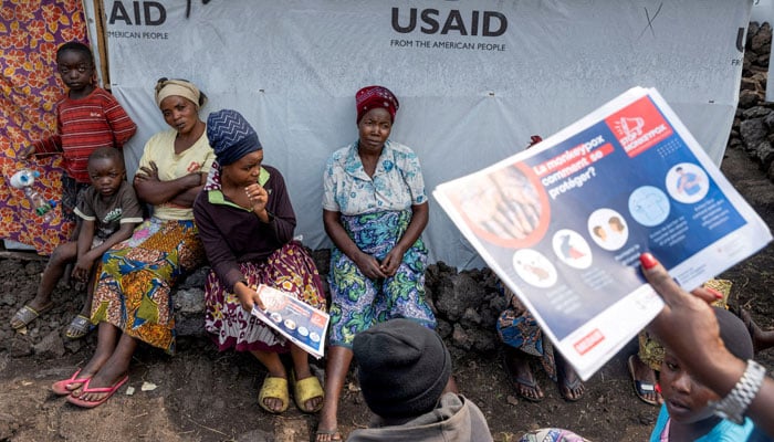 Internally displaced women listen to Nathalie Kipenzi, a hygiene promoter, during an awareness campaign for Mpox, an infectious disease caused by the Mpox virus that causes a painful rash, enlarged lymph nodes and fever, at the Muja camp for the internally displaced in Nyiragongo territory, near Goma in North Kivu province of the Democratic Republic of Congo on August 19, 2024. — REUTERS