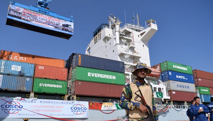 Pakistani Navy personnel stand guard near a ship carrying containers at the Gwadar port, some 700km west of Karachi, during the opening ceremony of a pilot trade programme between Pakistan and China on November 13, 2016. — AFP