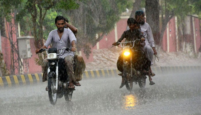 Motorcyclists navigate through the city rain during the monsoon season in Hyderabad on August 2, 2024. — APP