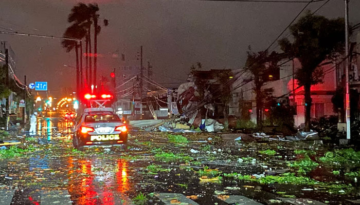 A police car drives amid destruction from Typhoon Shanshan in Miyazaki city, Japan on August 29, 2024. — Reuters