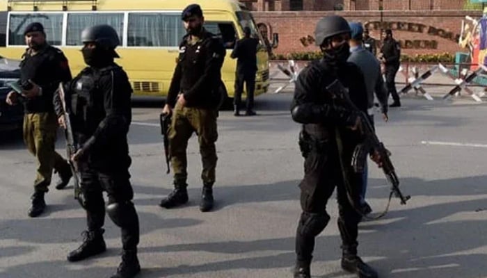 Representation photo shows Lahore policemen standing ready during a search and combing operation. — APP