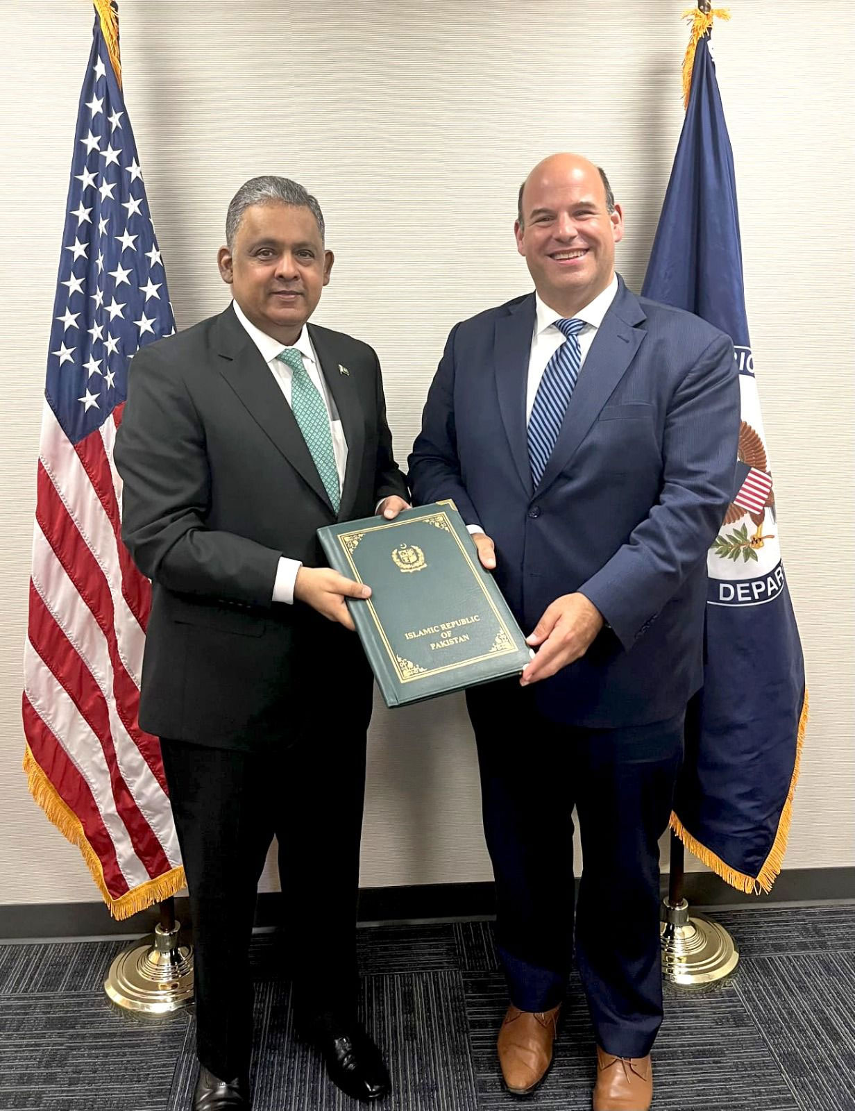 Pakistans Ambassador to US Rizwan Saeed Sheikh (right) receives a copy of credentials for his new role. — Pakistan Embassy