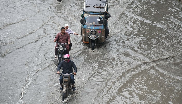 Traffic drive through a flooded road caused by heavy monsoon rainfall in Karachi on August 31, 2024. — Online